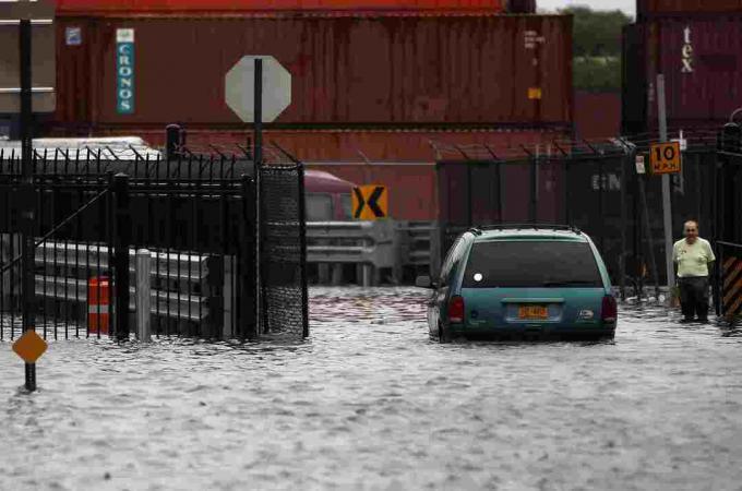 Osoba chodí po zatopenej ulici po hurikáne Irene 28. augusta 2011 v štvrti Red Hook v časti Brooklyn v New Yorku.