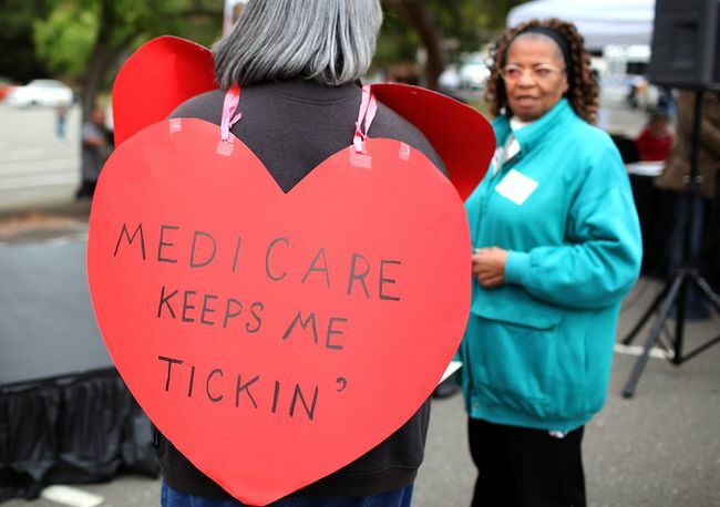 Žena s nápisom v tvare srdca s nápisom „Medicare ma stále tiká“